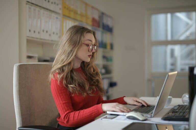 A dedicated female freelancer working on a laptop from her home office. accounting accounting solutions