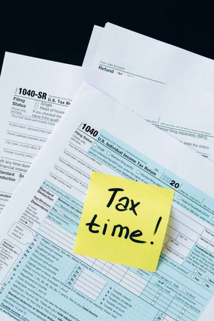 Master Your Finances with the Best Tax Planner for Every Need 1 IRS 1040 tax forms with handwritten 'Tax Time!' note for filing reminder.
