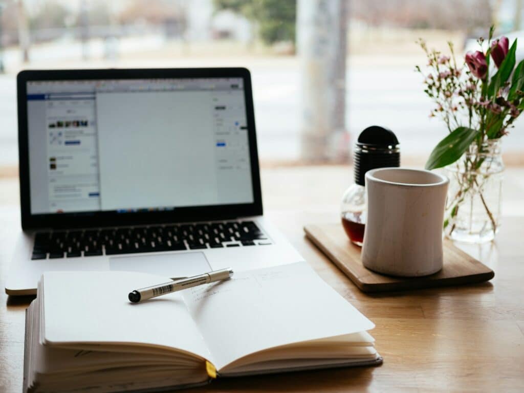 The Benefits of Hiring a CFO Outsourced for Your Business Growth 2 MacBook Pro near white open book