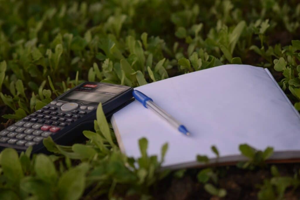 blue ballpoint pen on paper beside calculator cash vs accrual accounting