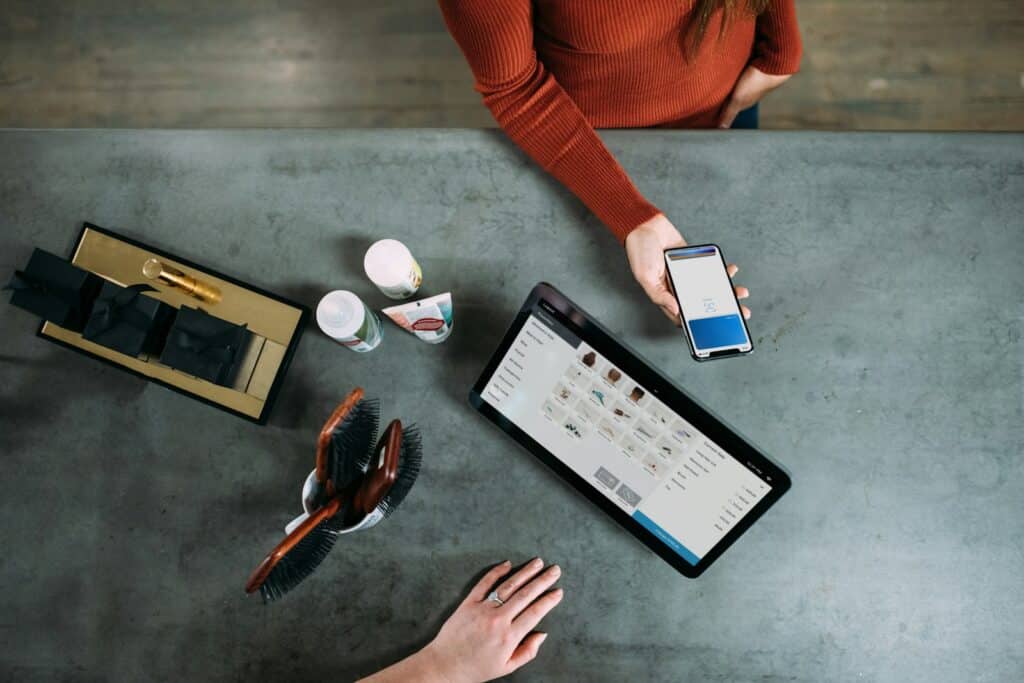 The Benefits of Hiring a CFO Outsourced for Your Business Growth 4 person holding smartphone beside tablet computer